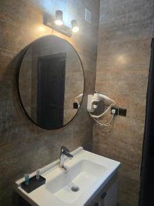 a bathroom with a sink and a mirror on the wall at ALULA WINTER in Al-ʿUla