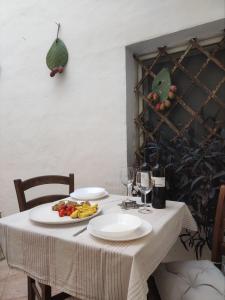 a white table with a plate of food on it at Casa vacanza Gallipoli centro in Gallipoli +20 photos