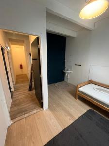 a room with a bed and a hallway at Pension Veldzigt in Wijnaldum