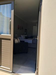 a view of a bedroom with a bed and a couch at Silwerrand in Beaufort West