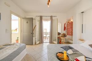 a bedroom with a bed with a tray of food on it at Little Yard Studios & Apartments #6 in Naxos Chora