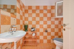 a bathroom with a sink and a toilet at Little Yard Studios & Apartments #6 in Naxos Chora +31 photos
