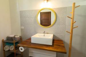 a bathroom with a sink and a mirror at Tortuga HBH in Playa Hermosa +31 photos