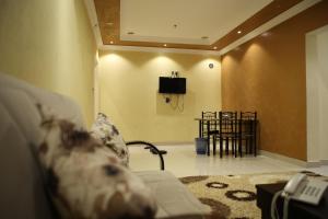 a living room with a couch and a tv at Beauty Rayan 2 in Jazan