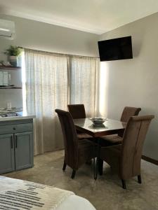 a dining room table and chairs in a room at Mata Rocks Resort in San Pedro