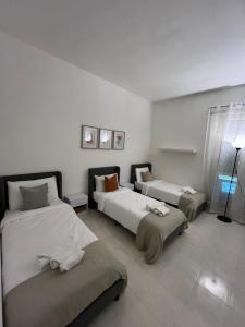 a bedroom with two beds and a lamp in it at CozyNeat Hub in Turin