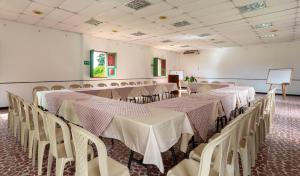 a conference room with tables and chairs and a podium at Hotel campestre La Floresta in Armenia +72 photos