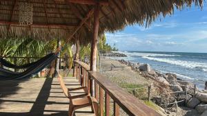 a hammock on a beach with the ocean at The Chill Inn in Jiquilillo