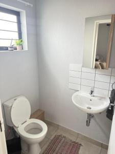 a white bathroom with a toilet and a sink at Monochrome View in Nelspruit +16 photos