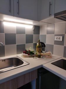 a kitchen counter with a sink and a bottle of wine at Villa Katerina in Chania +167 photos