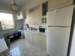 a kitchen with a white refrigerator and a window at Affittacamere LICEN in Trieste +42 photos