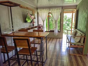 a kitchen with a table and chairs in a room at Papaturro House in La Cruz +25 photos