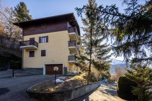 a building with balconies on the side of a road at Bormio's Balcony - At the Spa in Premadio
