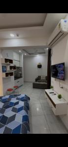 a living room with a bed and a couch at The dream studio in Noida