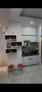 a kitchen with two red chairs and a counter at The dream studio in Noida +3 photos