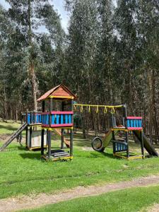 two childrens playground equipment in a park at GLAMPING RESERVA CATEDRAL Zipaquira in Zipaquirá