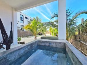 a swimming pool in the backyard of a house at Casa del Mar Holbox in Holbox Island +26 photos