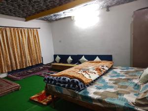 a bedroom with a bed and a couch in a room at Daar home stay in Kaja