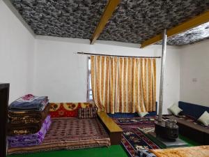 a living room with a bed and a window at Daar home stay in Kaja
