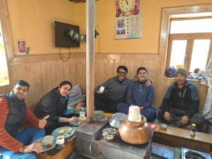 a group of people sitting around a table at Daar home stay in Kaja