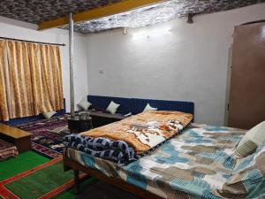a bedroom with a bed and a couch in a room at Daar home stay in Kaja
