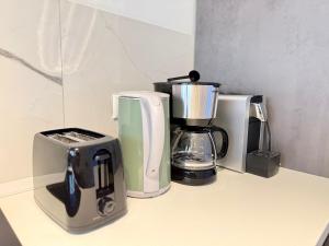 a counter top with various appliances on it at Business Apartment City 5 Betten & Parkplatz in Lüdenscheid +5 photos