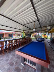 a pool table on a patio with awning at Rancho Akila in Filandia