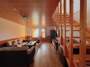 a living room with a spiral staircase in a house at Cingjing Brilliant Twins of Seattle in Ren'ai