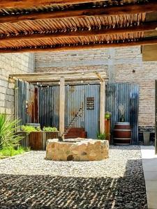 a patio with a stone bench in front of a building at A lo de Pepa in Tupungato