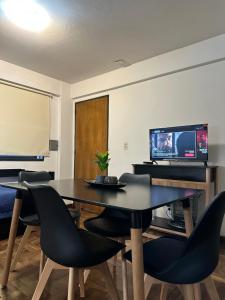 a meeting room with a table and chairs and a screen at Espacio necochea in Mendoza