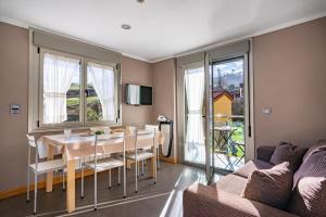 a living room with a table and a couch at Apartamentos Spa Cueto in Cangas de Onís
