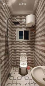 a bathroom with a toilet and a sink at Stepping Stone Apartments in Bijilo +9 photos