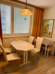 a dining room with a table and chairs and a window at Apartmán BlueA in Jihlava +16 photos