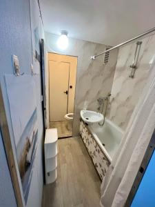 a bathroom with a sink and a tub and a toilet at Apartmán BlueA in Jihlava