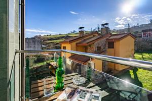 a balcony with a view of a house at Apartamentos Spa Cueto in Cangas de Onís