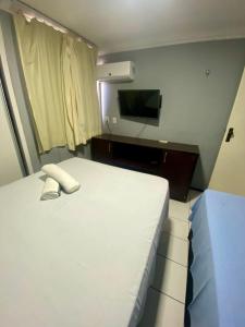 a hotel room with a bed and a television at APARTAMENTO EM NATAL III in Natal +31 photos