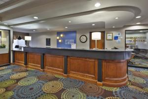 a bar in a hotel lobby with a clock on the wall at Holiday Inn Express Hotel & Suites - Belleville Area by IHG in Belleville +134 photos