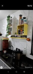 a kitchen with a counter with a pot on a stove at Eva in Vila Velha