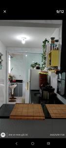 a kitchen with a white refrigerator and a sink at Eva in Vila Velha