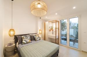 a bedroom with a bed and a pendant light at Anemone House in Mesokhórion
