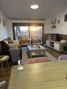 a living room with a couch and a table at Valdefornos in Pontevedra