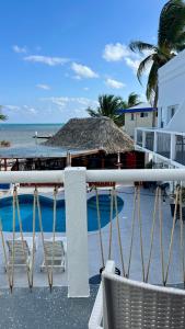 a view of the ocean from the balcony of a resort at Mata Rocks Resort in San Pedro