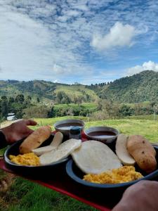 a tray of food on a table with a plate of food at Glamping La Maestranza con desayuno incluido in Villamaría +6 photos