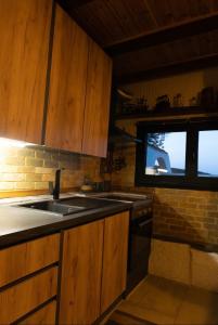 a kitchen with a sink and a window at Villa Haris in Sarti +34 photos