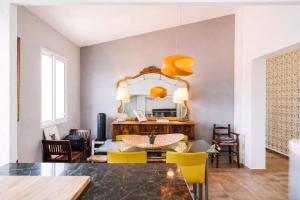 a dining room with a table and yellow chairs at heart & ponie - Retiro Rural Privado con Piscinas in Chinchón
