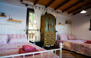 a bedroom with two beds and a dresser at Villa Haris in Sarti