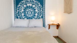 a bedroom with a bed with a blue and white headboard at GALA Santa Teresa Studios - Walk to Beach & Surf in Santa Teresa Beach