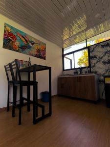 a room with a table and a chair and a window at Alma Luna Chalet in Vergara +11 photos