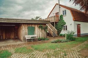 a house with a wooden garage and a deck at Ferienwohnung Ausblick in Süderbrarup