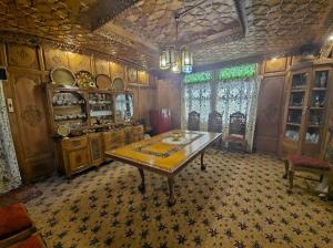 a dining room with a table in the middle at Cheetah Palace in Srinagar
